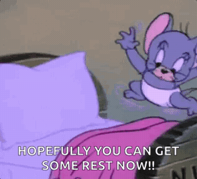 Cartoon Mouse Sitting On Bed With Pink Blanket And Purple Pillow GIF