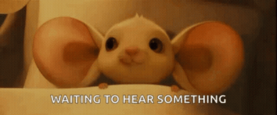 Cartoon Mouse With Large Ears Sitting On Table GIF