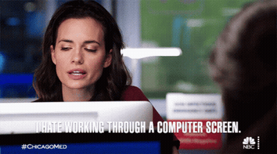 Cartoon Person Sitting At Desk With Two Laptops GIF