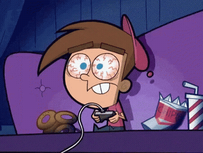 Cartoon Playing Video Game On Couch With Chips GIF