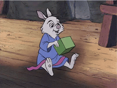 Cartoon Rabbit In Blue Robe Holding Green Block GIF