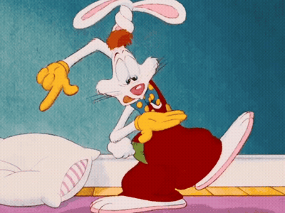 Cartoon Rabbit Pointing Next To Pillow GIF