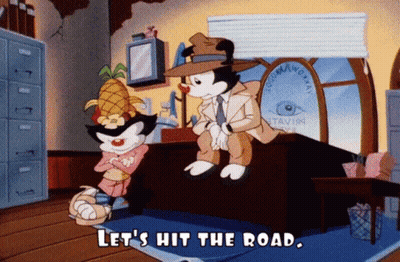 Cartoon Saying Let's Hit The Road Sitting On Desk GIF