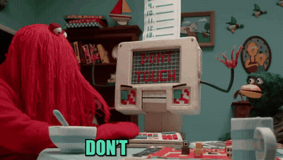 Cartoon Sitting At Table With Cereal And Don't Touch Sign GIF