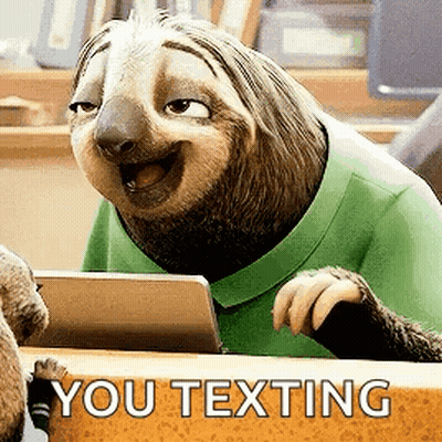 Cartoon Sloth Sitting At Desk Smiling GIF