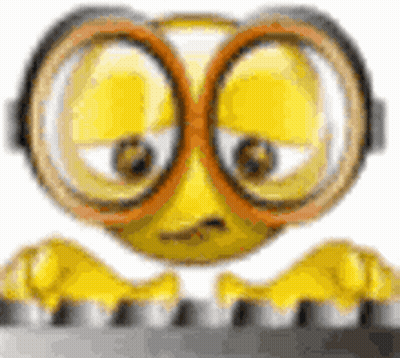 Cartoon Smiley Face Wearing Glasses And Goggles On Keyboard GIF