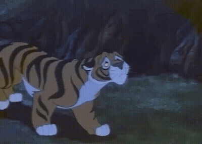 Cartoon Tiger Lying In Grass Looking At Camera GIF
