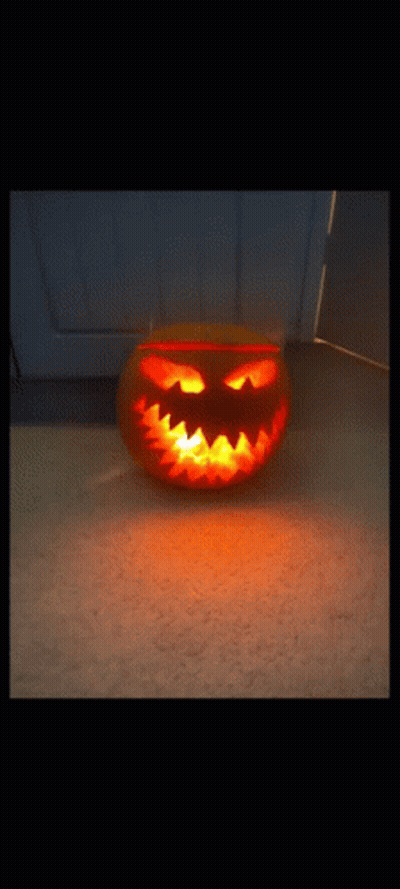 Carved Pumpkin With Glowing Face And Teeth GIF