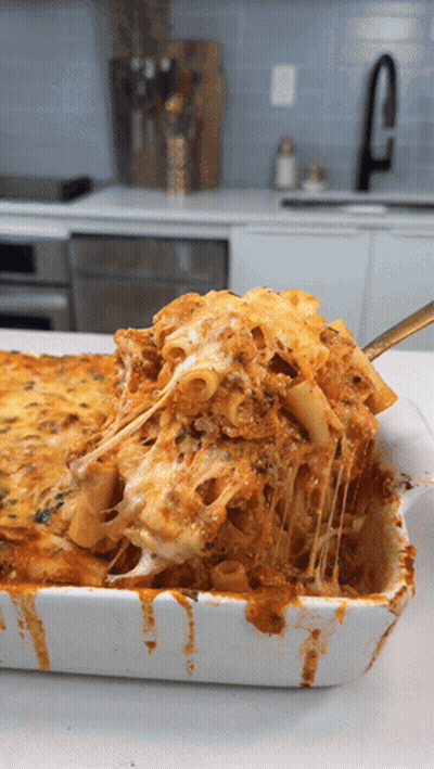 Casserole Dish With Pasta And Cheese And Spoon GIF