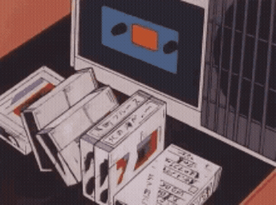 Cassette Tapes In Front Of Computer Monitor GIF