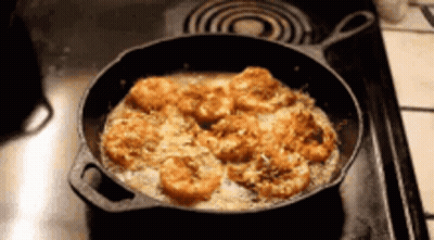 Cast Iron Skillet With Shrimp Cooking On Stove GIF
