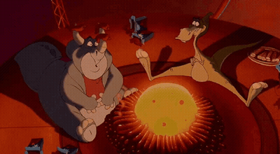 Cat And Dinosaur Sitting By Campfire GIF