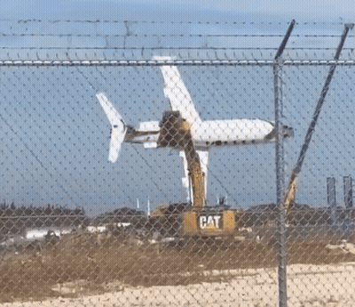 Cat Excavator Removing Plane GIF