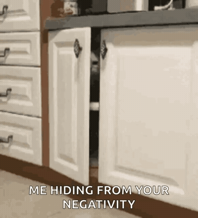 Cat Hiding Behind Cabinet Door GIF