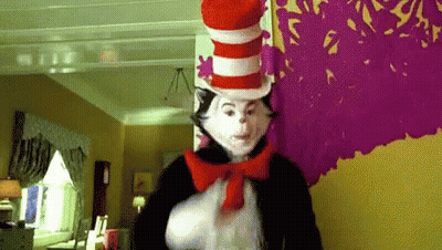 Cat In The Hat Standing By Purple Wall GIF