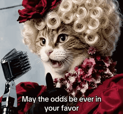 Cat In Wig Singing Into Microphone May The Odds Be Ever In Your Favor GIF