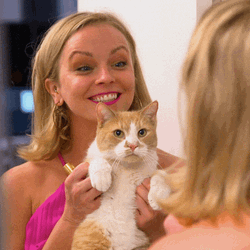Cat Lady Smiling In Front Of Mirror GIF
