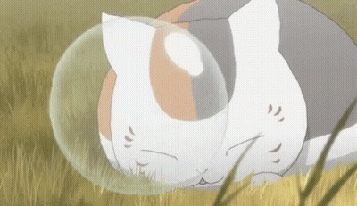 Cat Laying In Grass With Bubble Around Head GIF