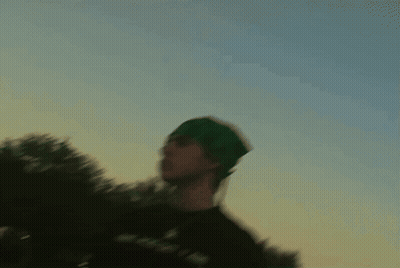 Cat Playing With Yellow Flower In Front Of Clock Saying 10:08 GIF