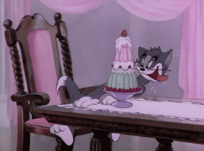 Cat Sitting at Table With Cake