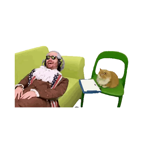 Cat Sitting on Green Chair Next to Man in Costume