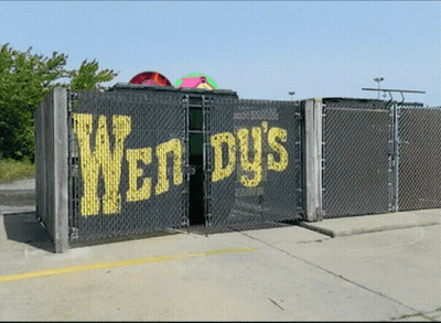 Chain Link Fence With Wendy's Written On It GIF