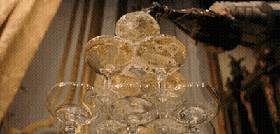 Champagne Poured Into Pyramid Of Glasses GIF