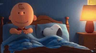 Charlie Brown And Snoopy Are Laying In A Bed Together . GIF