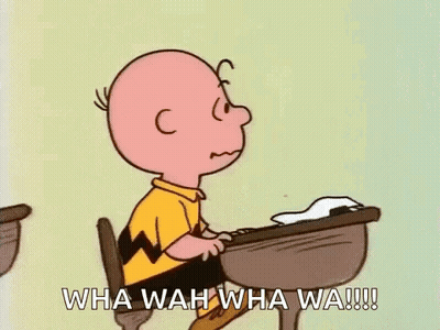 Charlie Brown Sitting At Desk With Hand To Chin GIF