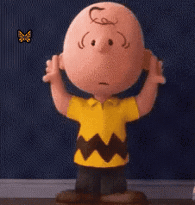 Charlie Brown Standing In Front Of Blue Wall With Butterfly GIF