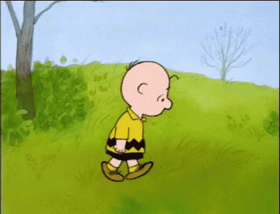Charlie Brown Walking On Grassy Field GIF
