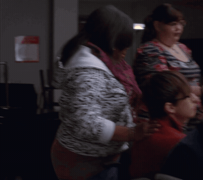 Cheerleader Getting Hair Done in Front of Crowd