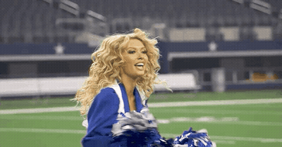 Cheerleader Holding Pom Poms On Football Field GIF