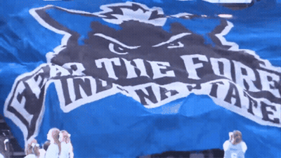 Cheerleader In Front Of Blue Banner Saying Fear The Fore GIF