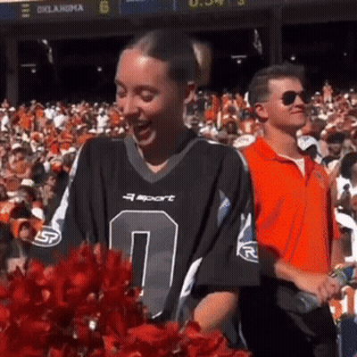 Cheerleader In Number 0 Jersey In Front Of Crowd GIF