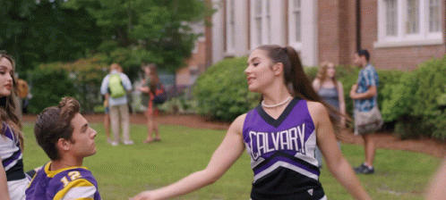 Cheerleader In Purple Salvary Uniform Dancing With Boy GIF