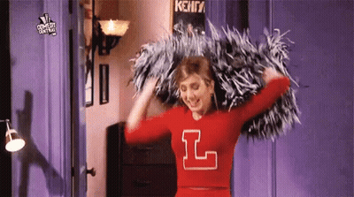 Cheerleader In Red Jersey Holding Pom Poms GIF