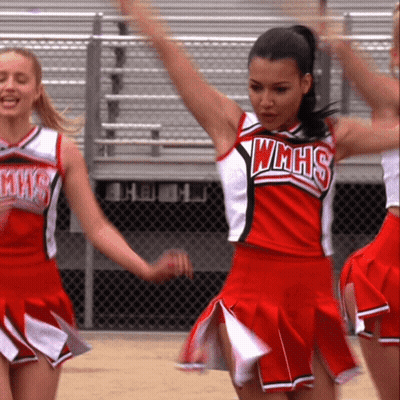 Cheerleader In WMHS Uniform Holding Arms Up GIF