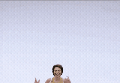 Cheerleader In Yellow And White Top With Letter E GIF