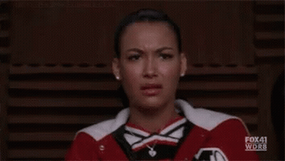 Cheerleader Making Funny Face in Red and White Jacket