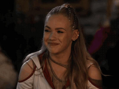 Cheerleader With Ponytail And Earrings Smiling GIF
