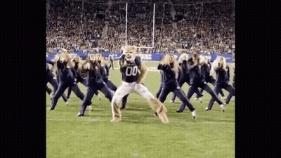 Cheerleaders Dancing With Mascot In Number 00 Jersey GIF