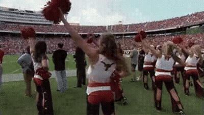 Cheerleaders Holding Pom Poms On Football Field GIF
