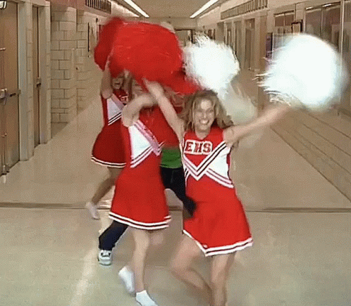 Cheerleaders In Ehs Uniforms Holding Pom Poms In Hallway GIF