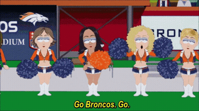 Cheerleaders In Front Of Broncos Sign GIF