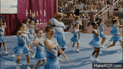 Cheerleaders Performing In Front Of County Junior Sign GIF