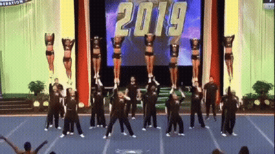 Cheerleaders Performing On Stage In Front Of 2019 Screen GIF