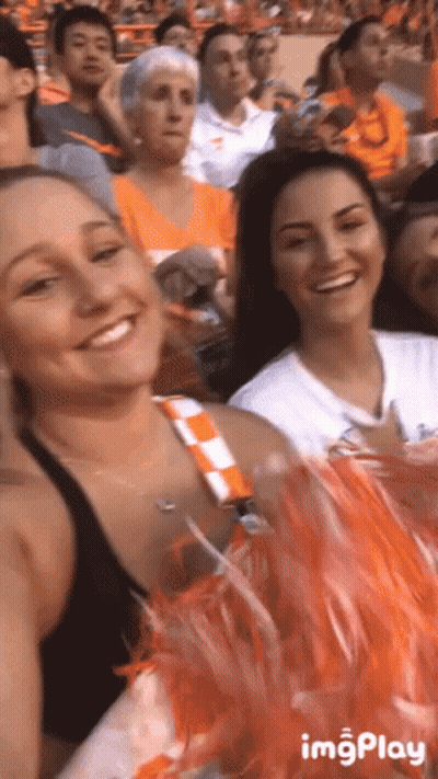 Cheerleaders Sitting In Stadium Smiling GIF