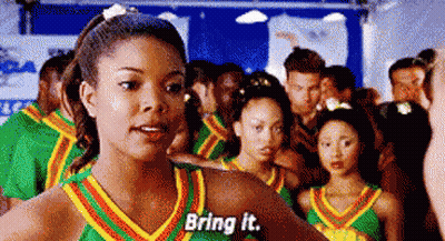 Cheerleaders Standing In Gym Talking To Camera GIF