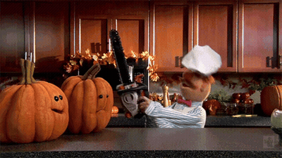 Chef Holding Chainsaw With Two Jack-O'-Lanterns GIF